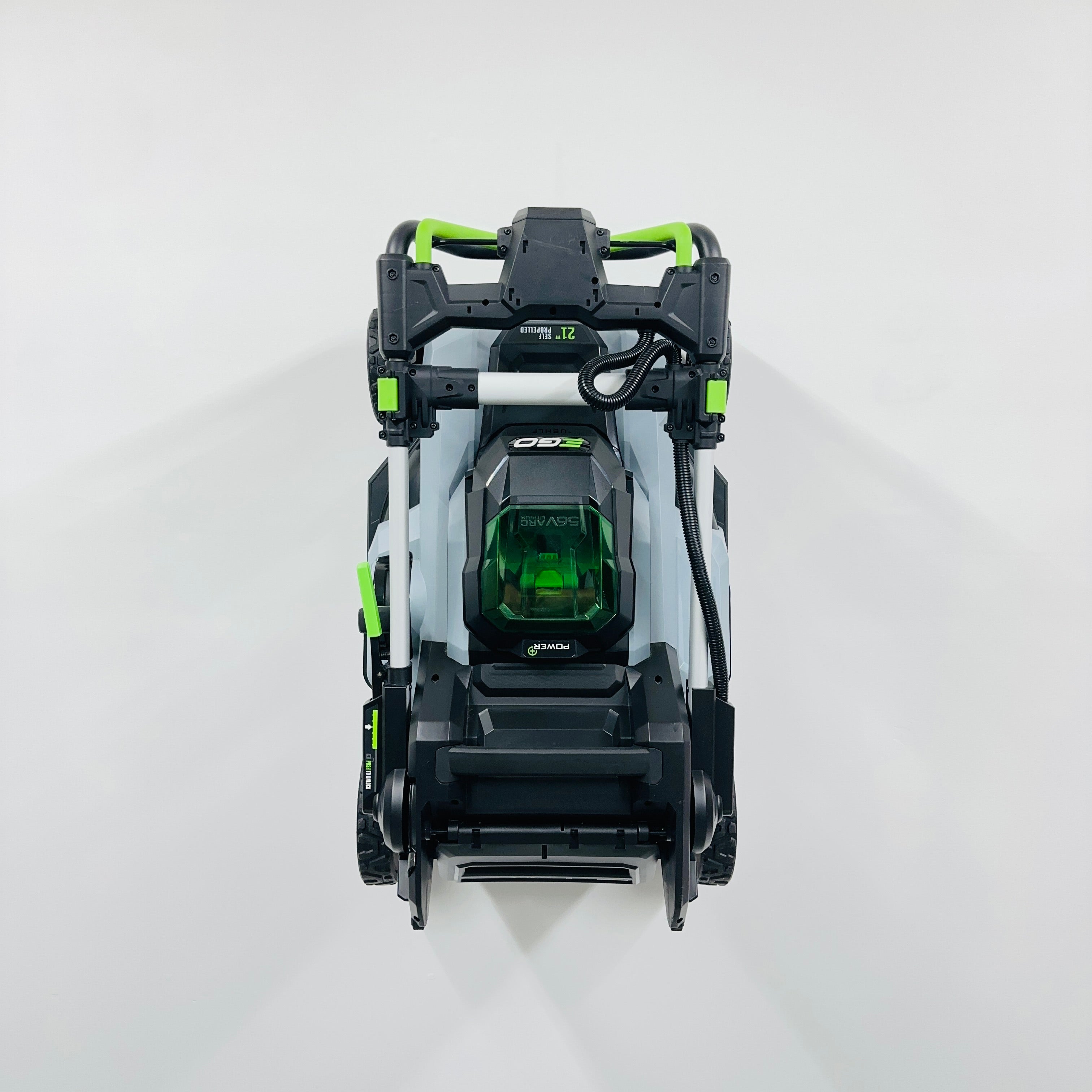 EGO push mower mounted on a wall using BennettBuilt Designs wall mount